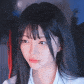 a girl with long black hair and bangs is wearing headphones .
