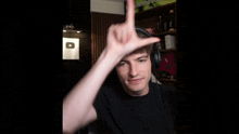 a man wearing headphones is making a hand gesture
