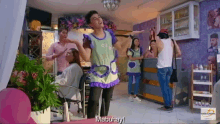 a man in an apron is dancing in a salon with the words mabuhay written on the bottom
