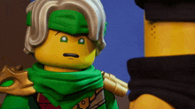 a lego figure with a green scarf around his neck looks at another lego figure