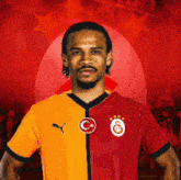 a man wearing a red and orange shirt with a c and g on it