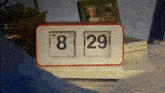 a flip clock displays the time as 8:29