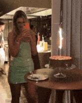 a woman in a green dress is taking a picture of herself
