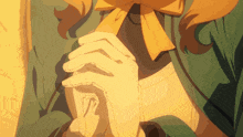 a close up of a person 's hands with a bow