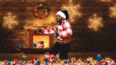 a man in a santa hat is dancing in front of a fireplace full of presents