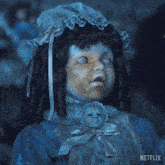 a netflix doll is holding a baby