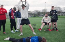 a man wearing a sweatshirt that says supreme is lifting a bar