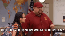 a man in a red shirt with the letter w on it is talking to a girl