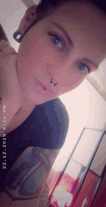 a woman with a tattoo on her arm takes a selfie at 6:16 pm on february 22 2019