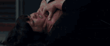 a woman is crawling on the floor with a gun