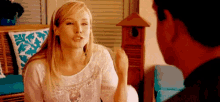 a woman is sitting next to a man in a living room .