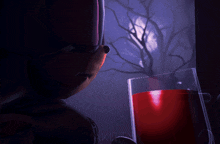 a person holding a glass of red liquid with the word drakitty on the bottom left