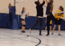 a blurred image of a volleyball game with a player wearing a jersey that says uc