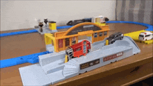 a toy train set with a truck that says ambulance on it