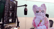 a stuffed animal is sitting in front of a computer