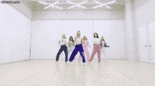 a group of girls are dancing in a room with the words honeycam.org at the top