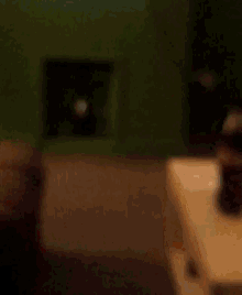 a bottle of coca cola sits on a table next to a person 's finger
