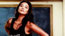 a woman wearing a black tank top that says " life is going "