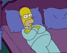 a cartoon of homer simpson laying on a bed with his arms crossed