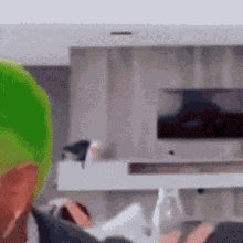 a blurred image of a living room with a green object in the foreground