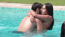 a man and a woman hugging in a swimming pool