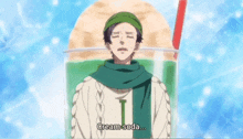 a man in a green scarf is standing in front of a cup that says cream soda