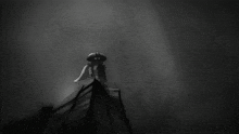 a black and white photo of a person standing on a building
