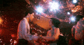 a man and a woman are dancing together on a dance floor in a disco .
