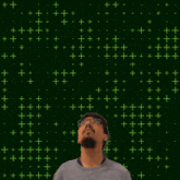 a man with glasses and a beard is looking up at the number 12