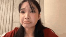 a close up of a woman making a sad face .