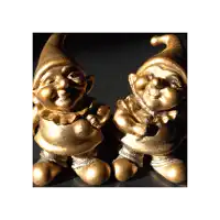 a couple of gold gnomes are sitting next to each other
