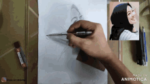 a person is drawing a picture of a woman with a hijab