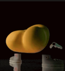 a yellow object is sitting on a table next to a pair of shoes