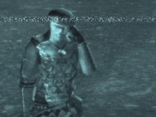 a man with a necklace around his neck is walking in a dark room