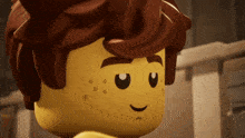 a close up of a lego man 's face with brown hair