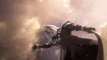 a man in a cape is flying through the air in a video game .