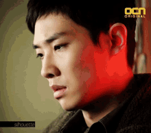 a close up of a man 's face with the ocn original logo above him