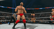 a wrestling match is being played in front of a crowd and a sign that says aew