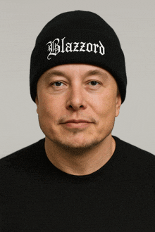 a man wearing a black beanie with blazzard embroidered on it