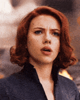 a close up of a woman 's face with red hair and freckles