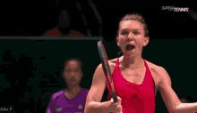 a woman in a red tank top holds a tennis racquet in front of a super tennis logo