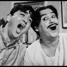 a black and white photo of two men with their mouths wide open