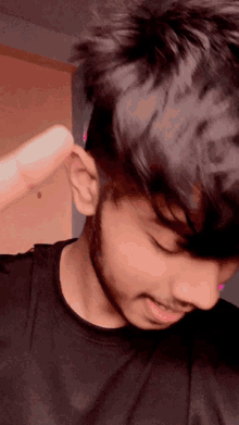 a close up of a man 's face with a beard and black shirt