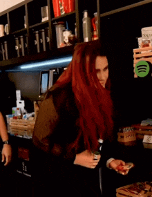 a woman with red hair is holding a bottle of o'neill 's