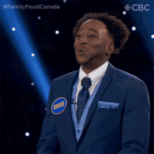 a man in a blue suit and tie has a badge on his chest that says wrathe