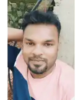 a man with a beard wearing a pink shirt