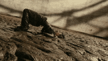 a person is laying on their back in a muddy area