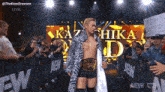 a wrestler is walking through a crowd with a sign that says " want what " on it