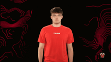a man wearing a red t-shirt that says tribe on it