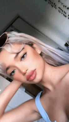 a woman taking a selfie with her hand on her chin